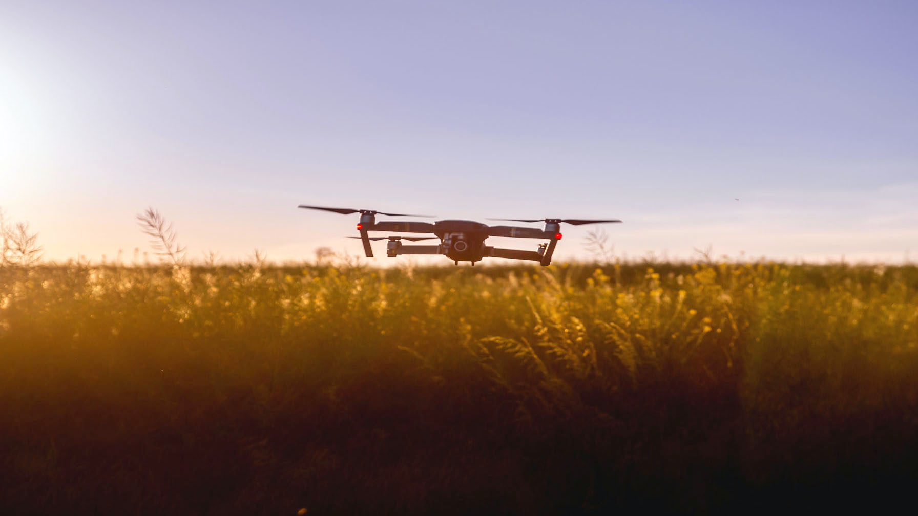 An agricultural drone flying over a field.