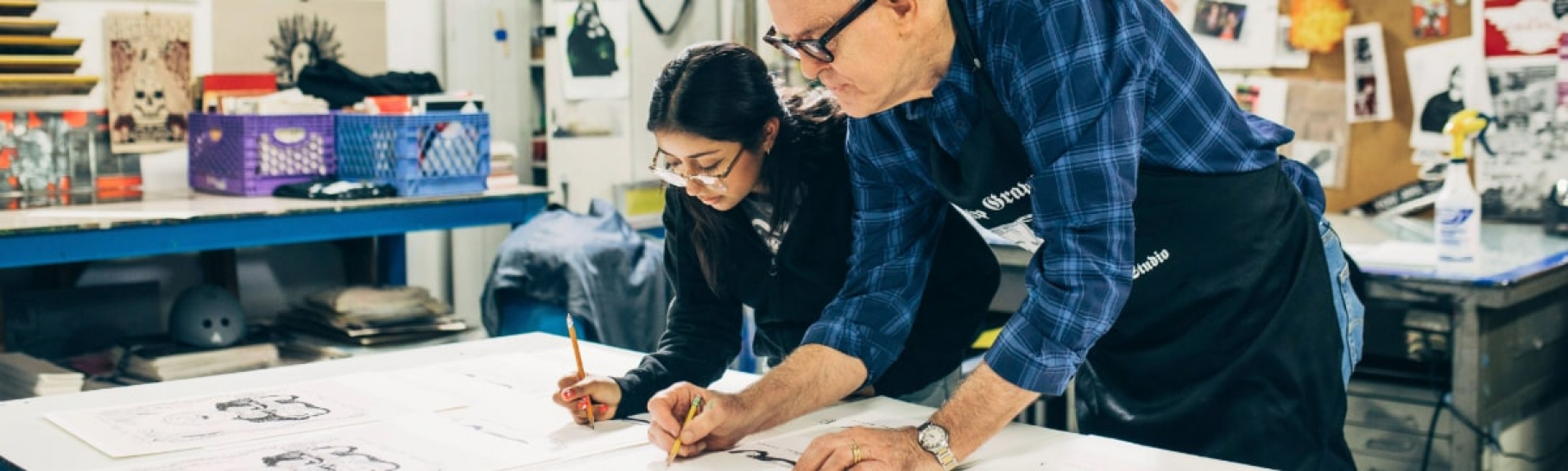 John Lithgow with a student learning how to draw