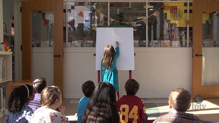 kids playing a communication game by drawing pictures to represent the words.
