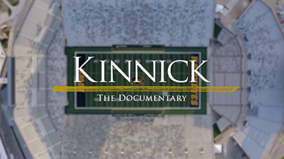 Kinnick: The Documentary logo over a top-down aerial shot of Kinnick Stadium in Iowa City, Iowa.