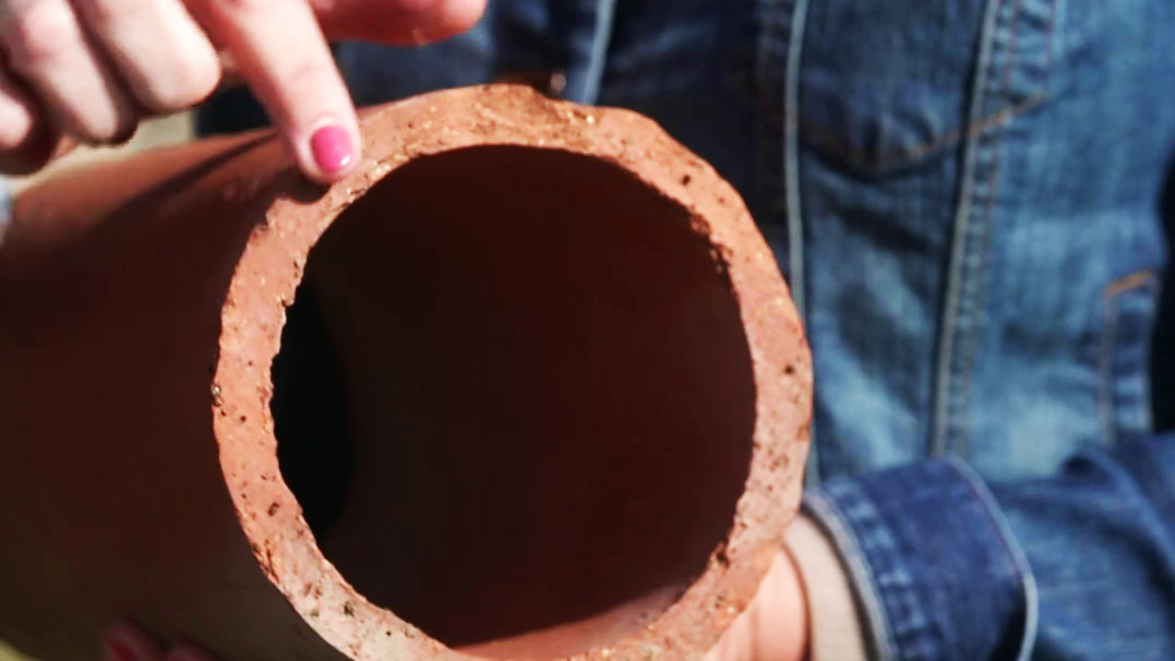 A cross section of an underground tile meant for managing water on the farm.