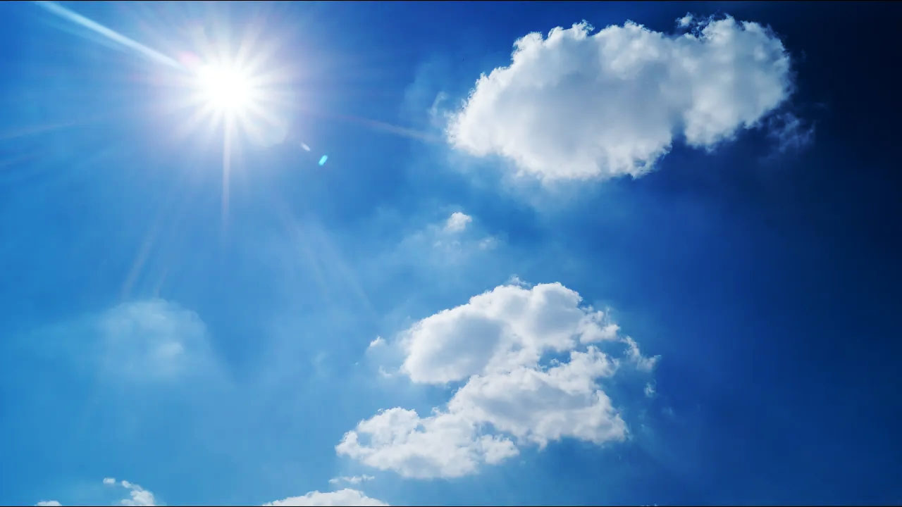 The sky on a sunny day, with a few clouds.