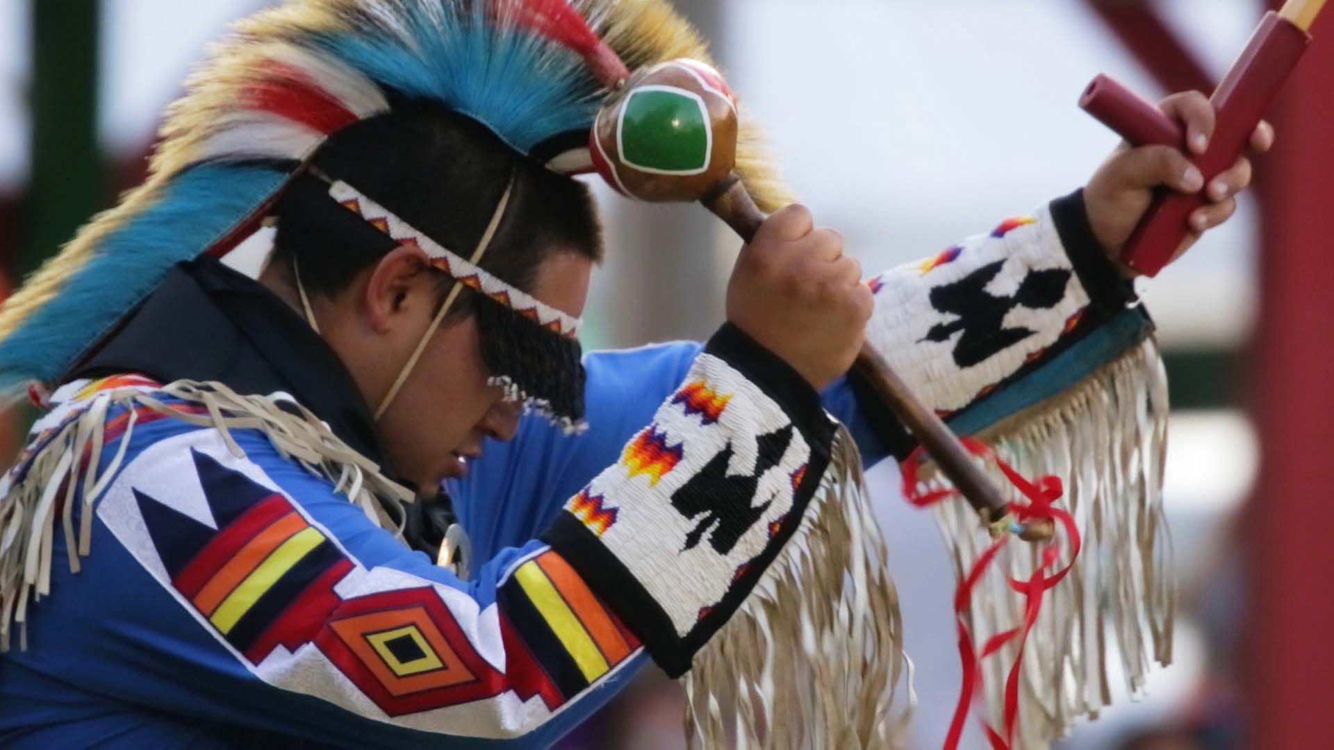 A Meskwaki Tribe member dancing at a powwow.