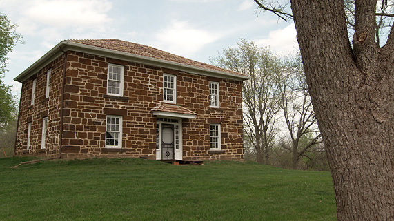 a two story brown brick house. The Hitchcock House Lewis, Iowa