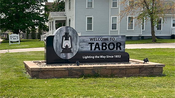 Tabor, Iowa town sign "Welcome to Tabor Lighting the Way Since 1852"