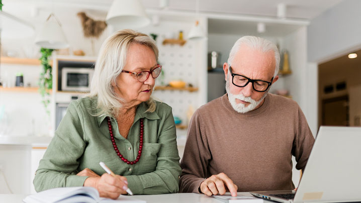 A woman and man look over documents.