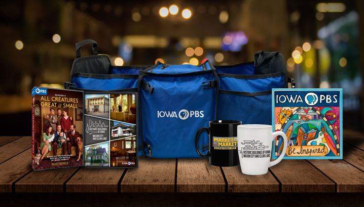 DVDs, special artwork, mugs, bags sit on a table.