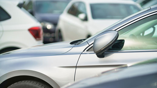 Silver and white cars parked in a lot.