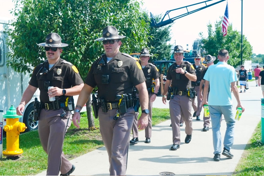 State troopers walking the Grand Concourse on Heroes' Day at the Iowa State Fair