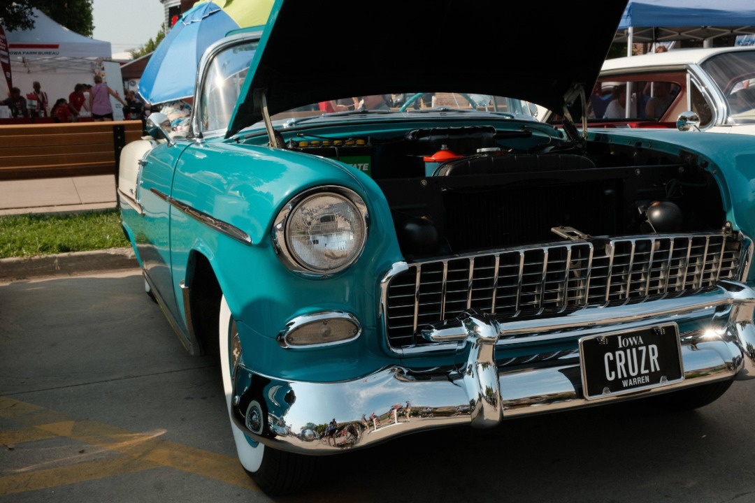 Teal classic car with its hood open