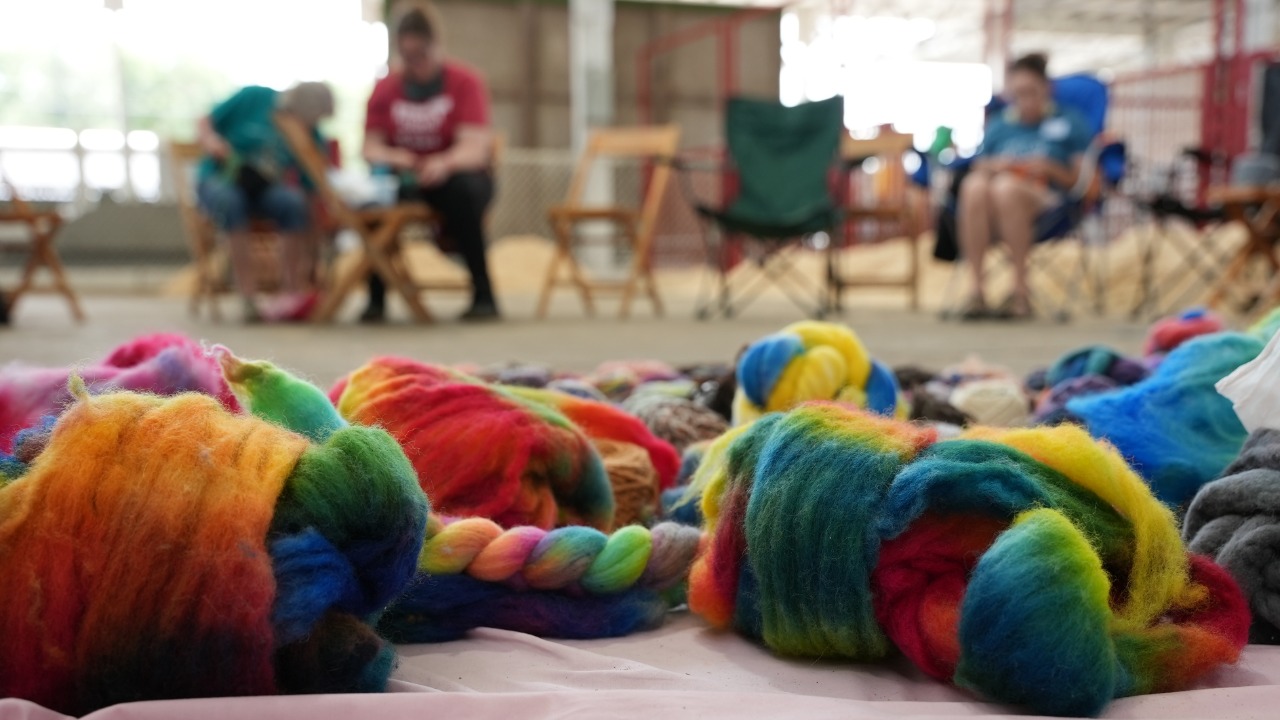 Brightly colored yarn on the floor of the sheep barn for the Spin & Knit event.