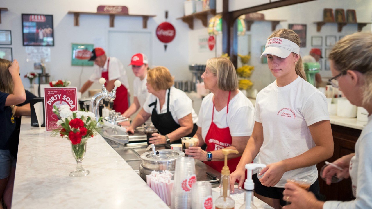 Workers serving customers at the Old Fashioned Soda Fountain
