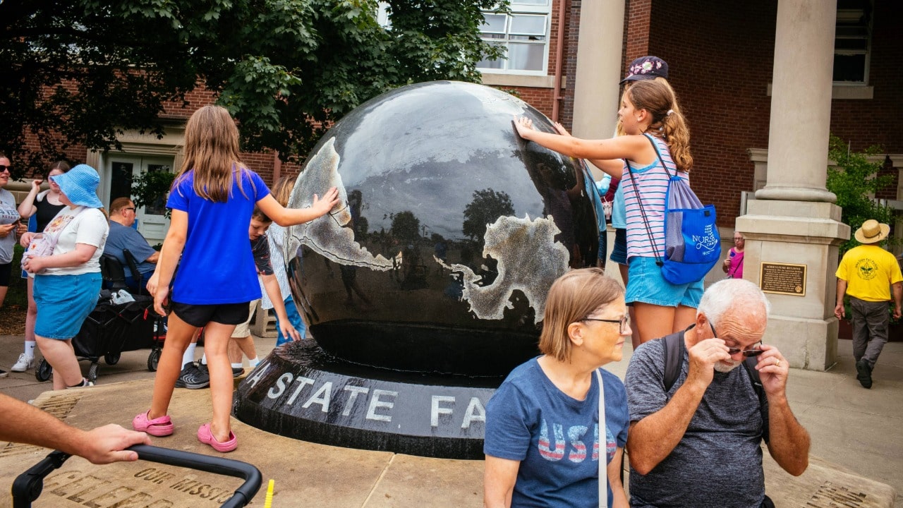 Young fairgoers interact with the state fair globe