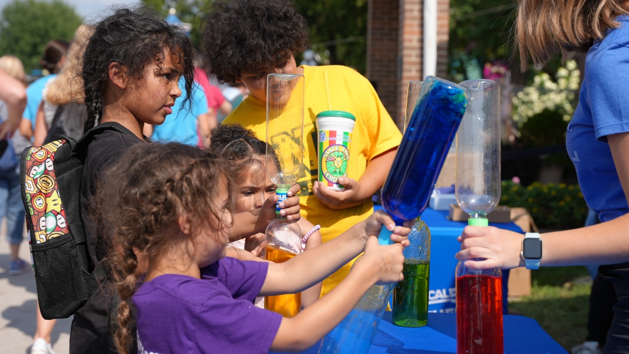 Kids playing with a tornado in a bottle