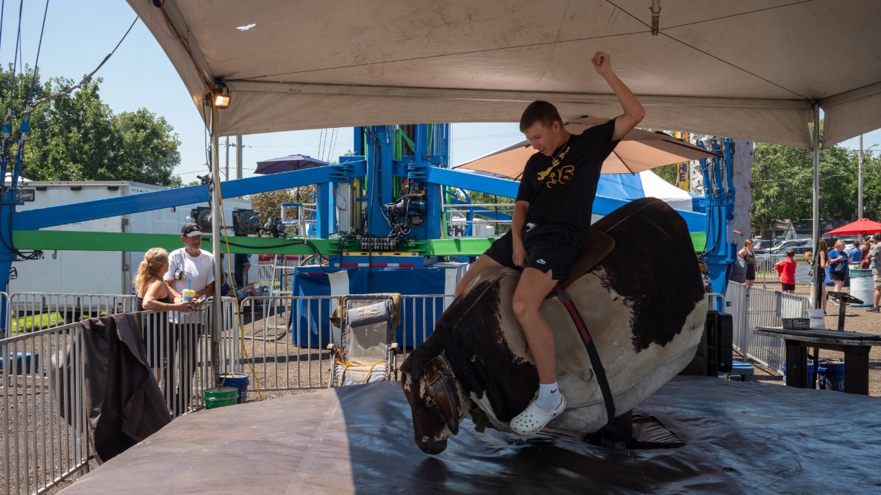 Boy riding a mechanical bull
