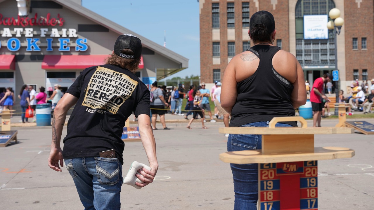 Cornhole tournament participants practicing on the Grand Concourse
