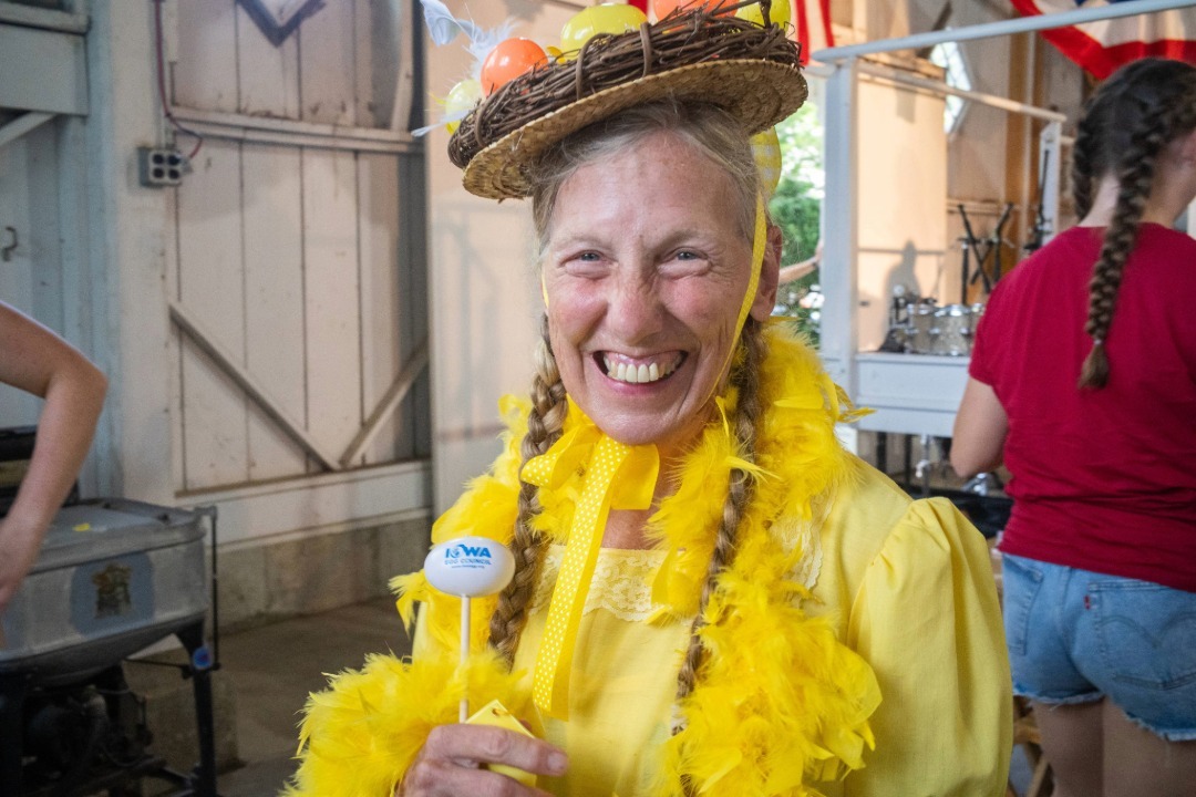 Chicken Calling participant wearing a feathered dress and egg hat
