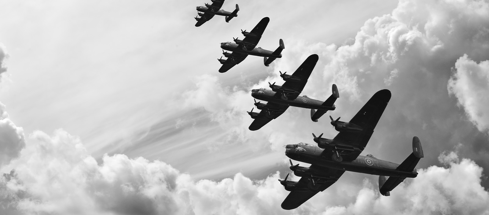 Planes from World War II flying across the sky.