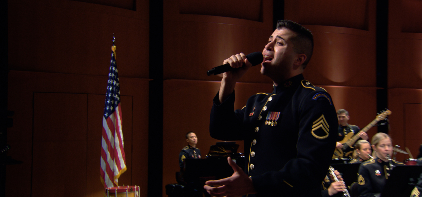 A man in military uniform singing