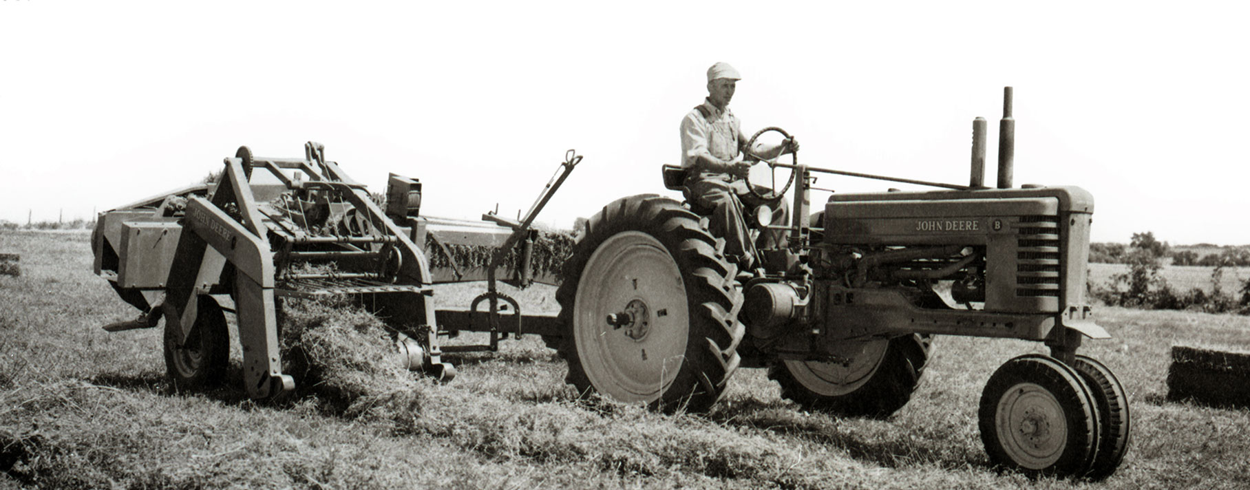 A man driving a John Deere tractor
