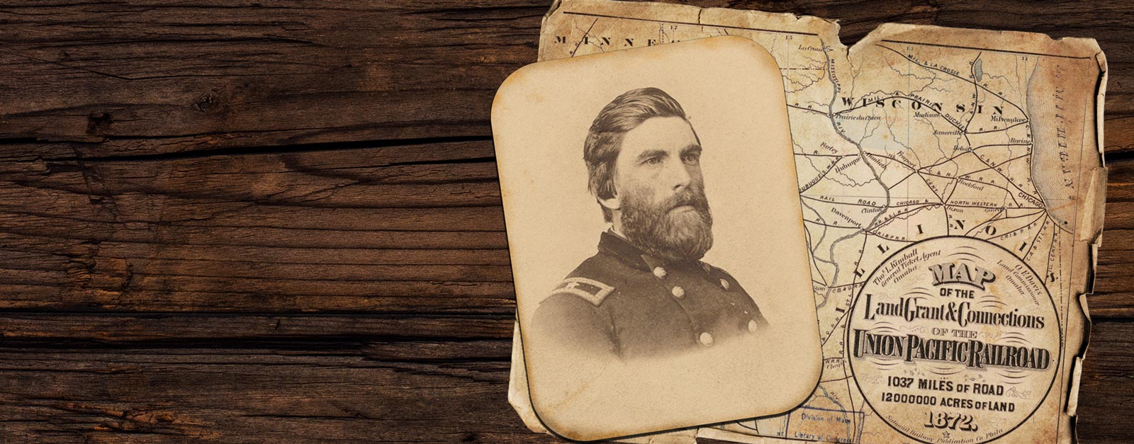 A man dressed in a Civil War era military uniform and a railroad map.