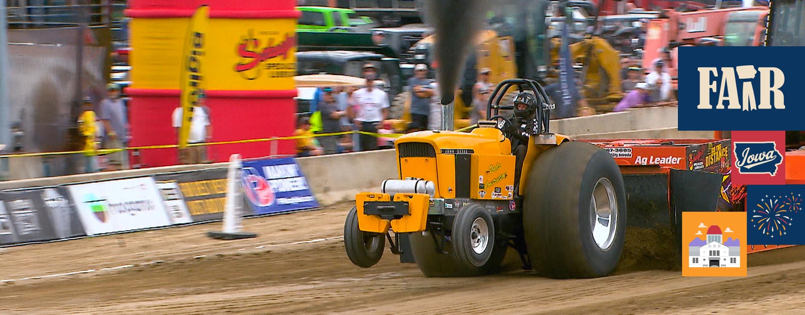 A yellow tractor competes in the truck and tractor pulls.