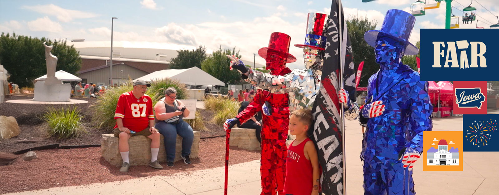 Three people in costumes made of red, silver and blue reflective glass pose for a picture.