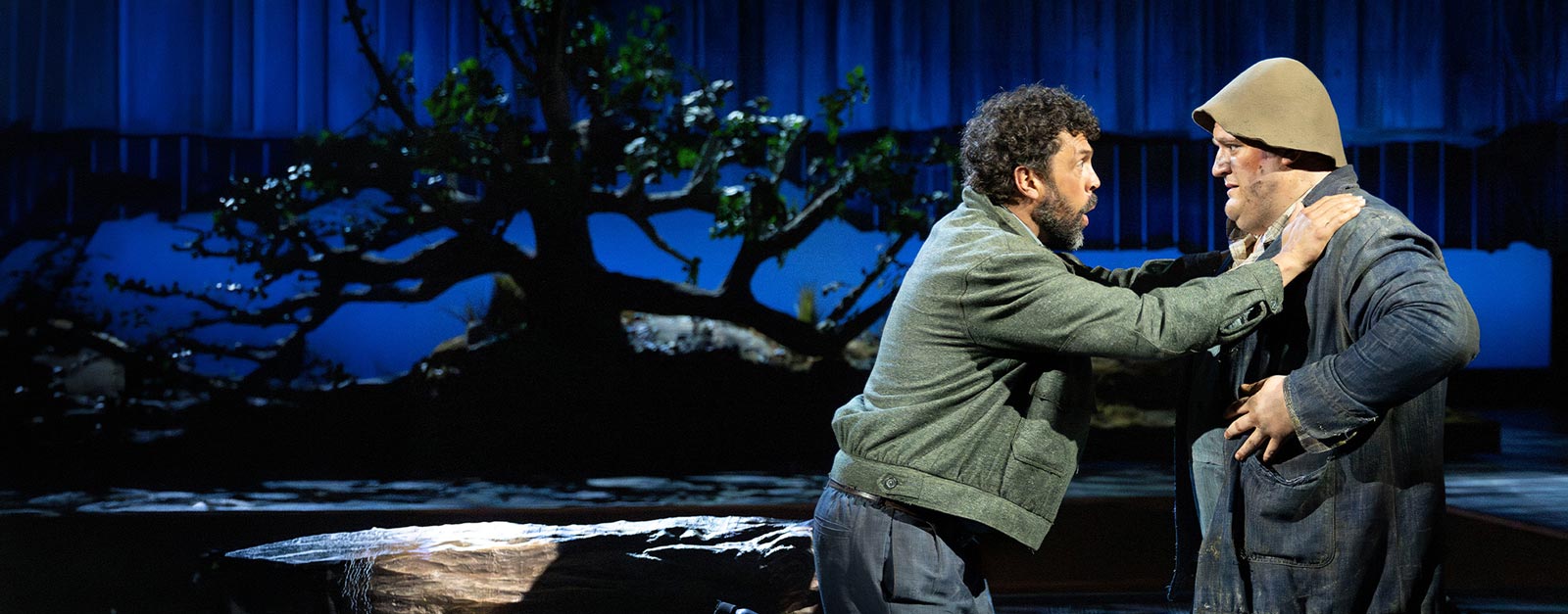 Two men on stage having a conversation.