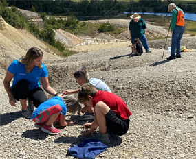 Image of kids and adults hunting for fossils.