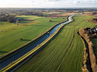 Image of a river running through a field.