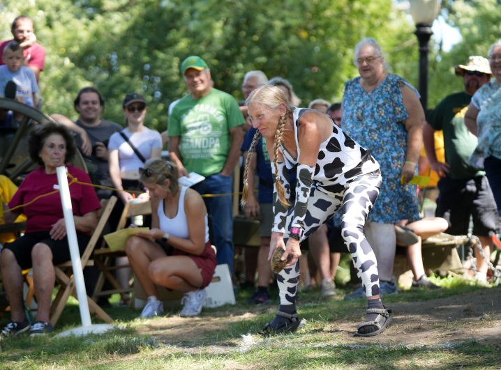 cow chip participant in a cow print outfit mid throw