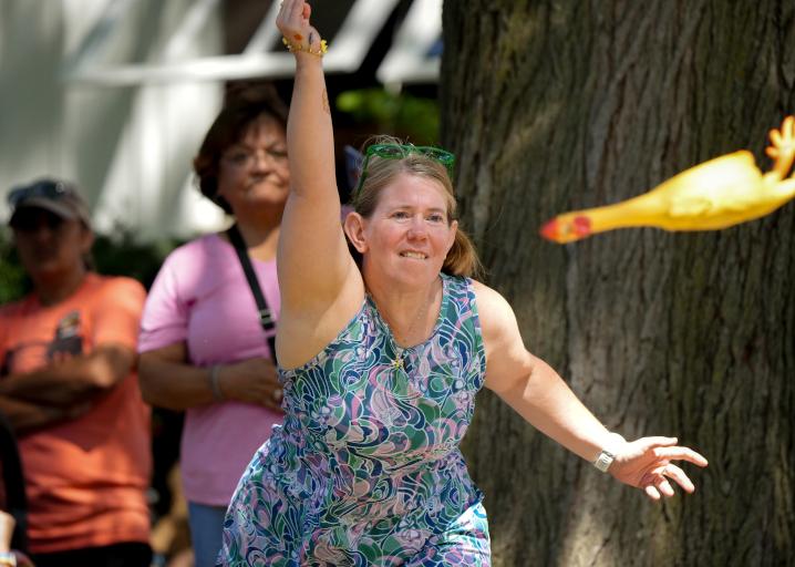 rubber chicken throwing participant mid throw