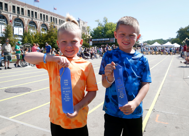 kids showing off ribbons from the big wheel race