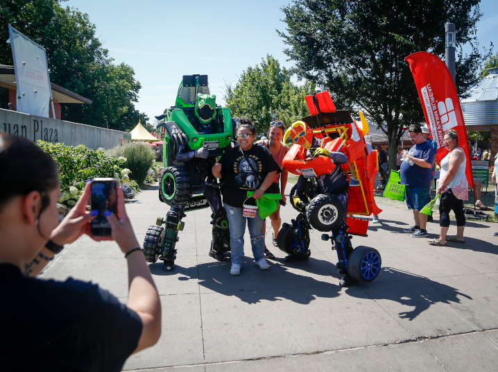 fairgoers posing with robocars