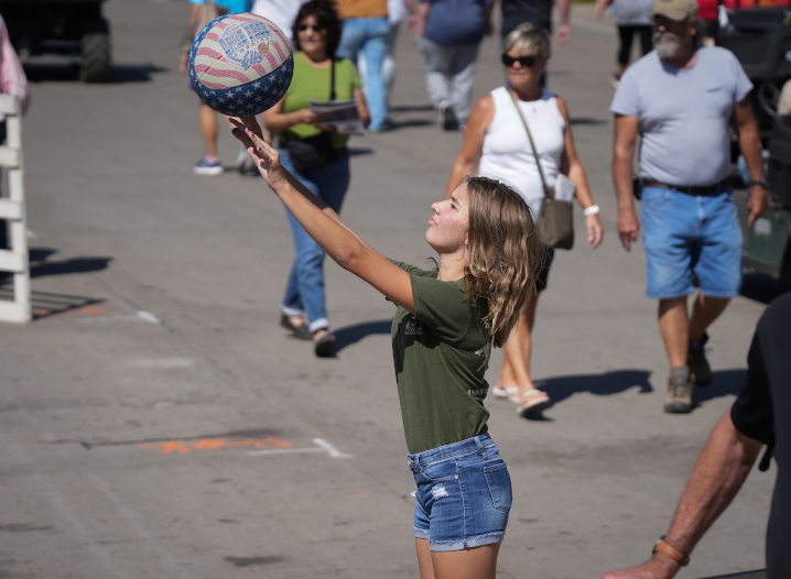 girl at the Iowa State Fair balancing a ball in her hands