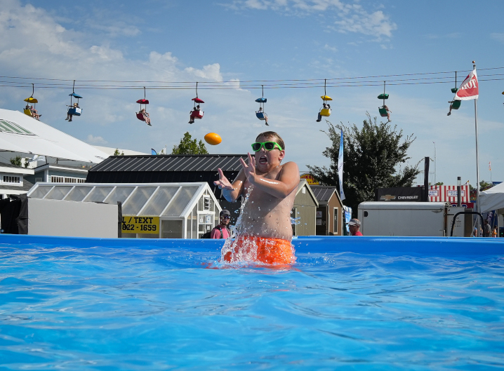 Coyce McNaul, 10, of Montezuma, cools off in a pool at the Iowa State Fair as temperatures soar above 90 degrees on Saturday, Aug. 19, 2023, at the Iowa State Fair