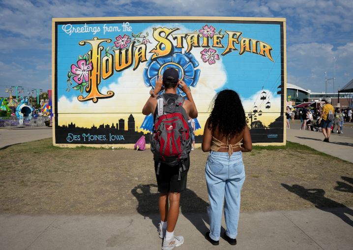 Fairgoers snap pictures of the Iowa State Fair mural
