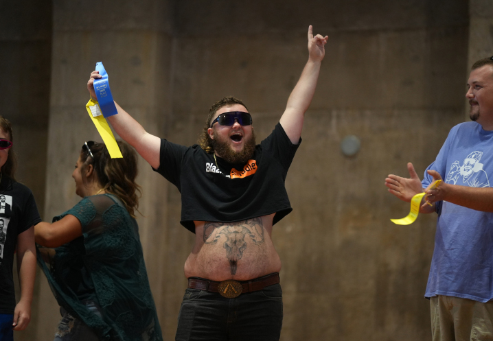 Adult mullet contest participant celebrating his ribbon.