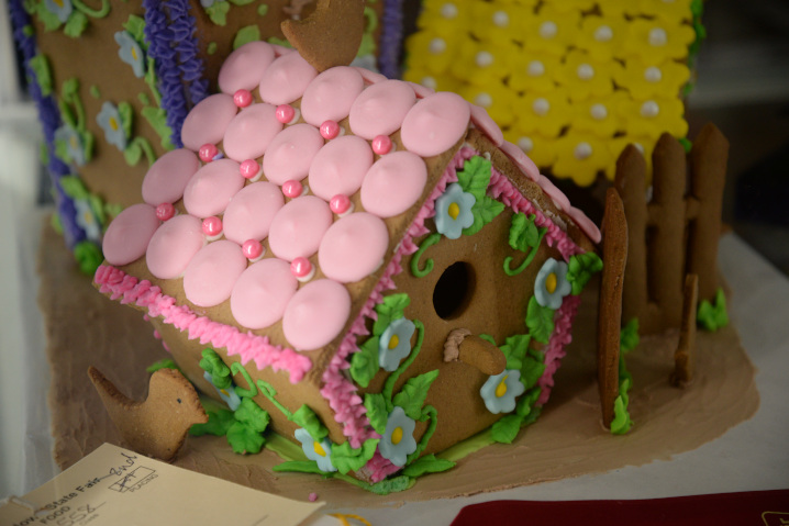 gingerbread house on display with a pink roof