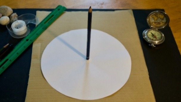 Where the pencil should be placed in the center of the sundial.