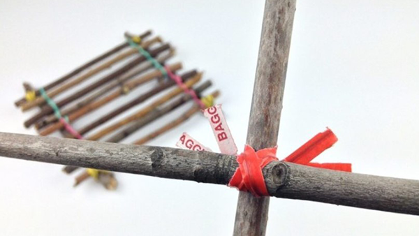 two sticks laid out in an ‘x’ formation, held together by twist ties.