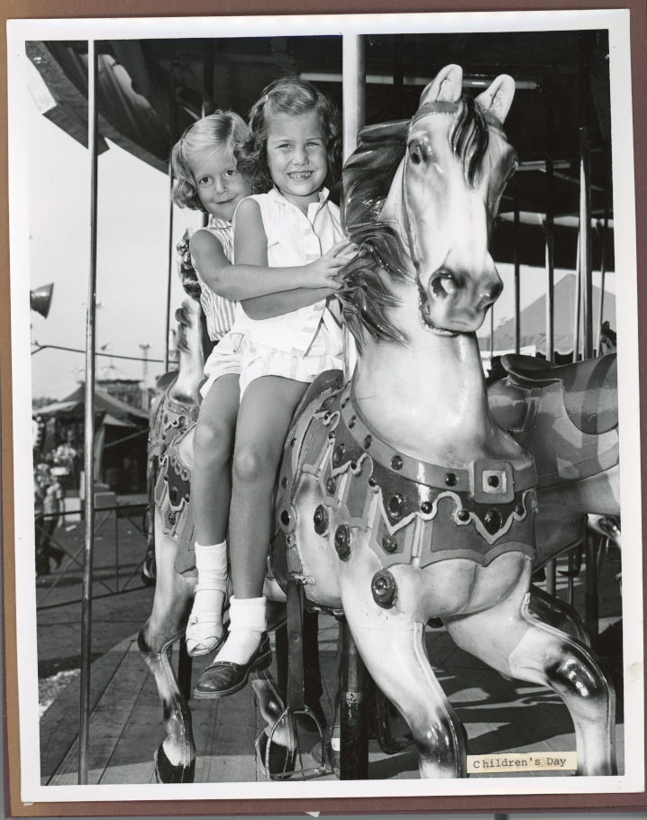 girls on carousel on midway