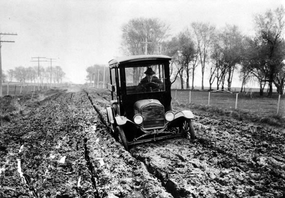 Car in Muddy Road Rut, ca. 1920