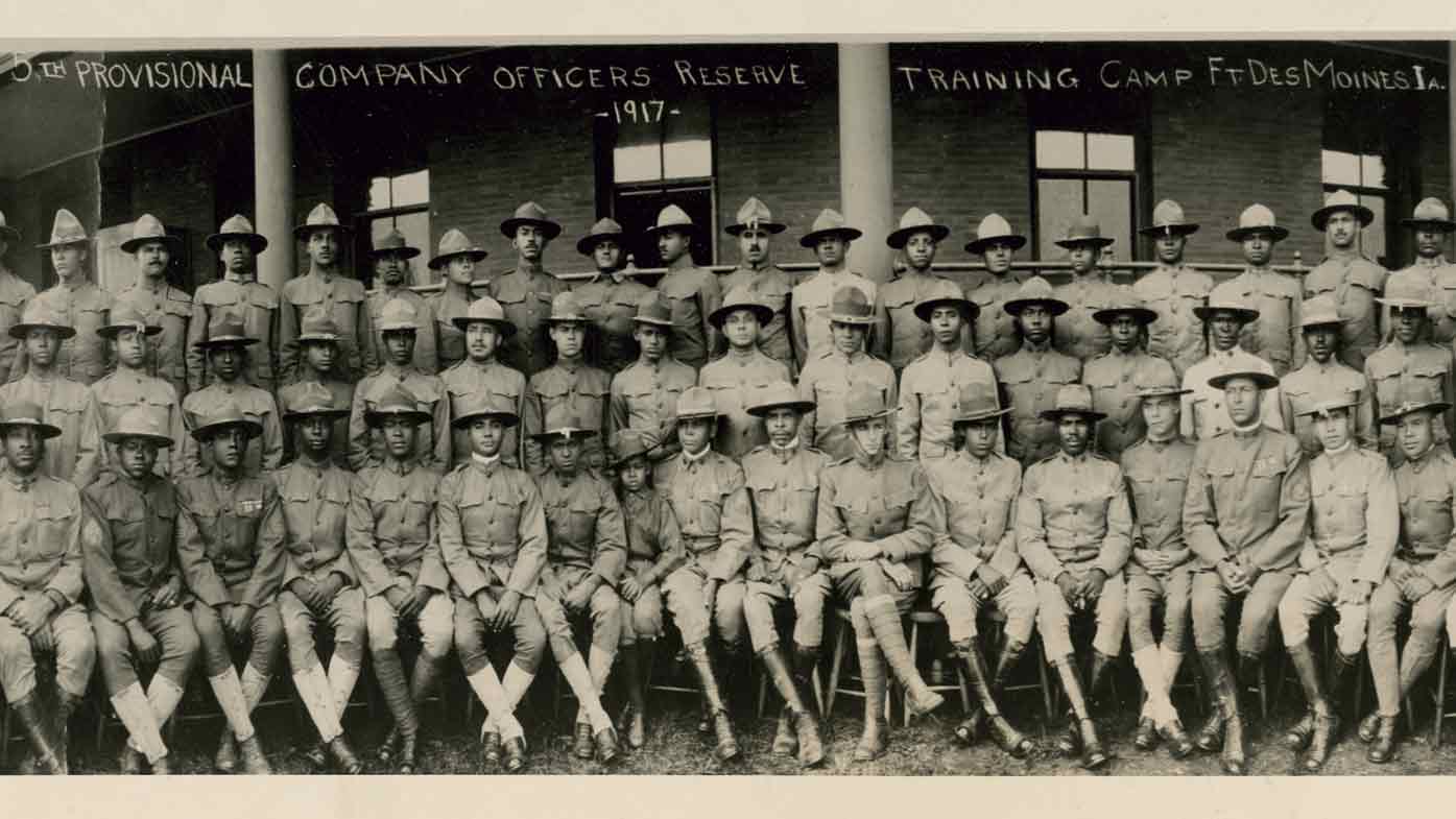 Group portrait of African American officers standing in front of a building at the Fort Des Moines Provisional Army Officer Training School in Des Moines, Iowa, in 1917