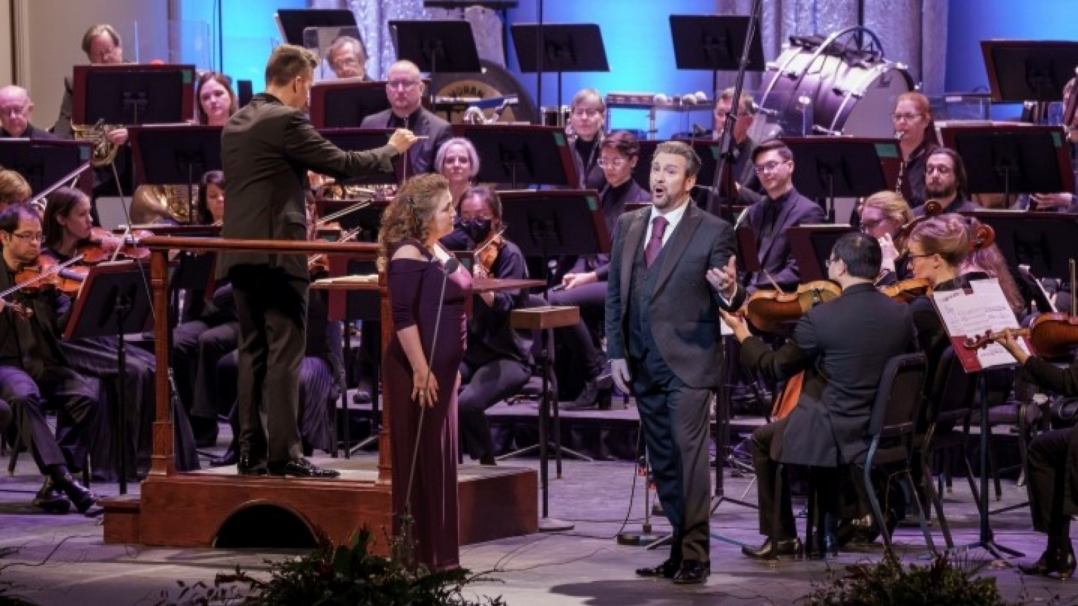 Renowned operatic tenor John Osborn and his wife, the celebrated soprano Lynette Tapia, performing onstage with the Sioux City Symphony Orchestra. 