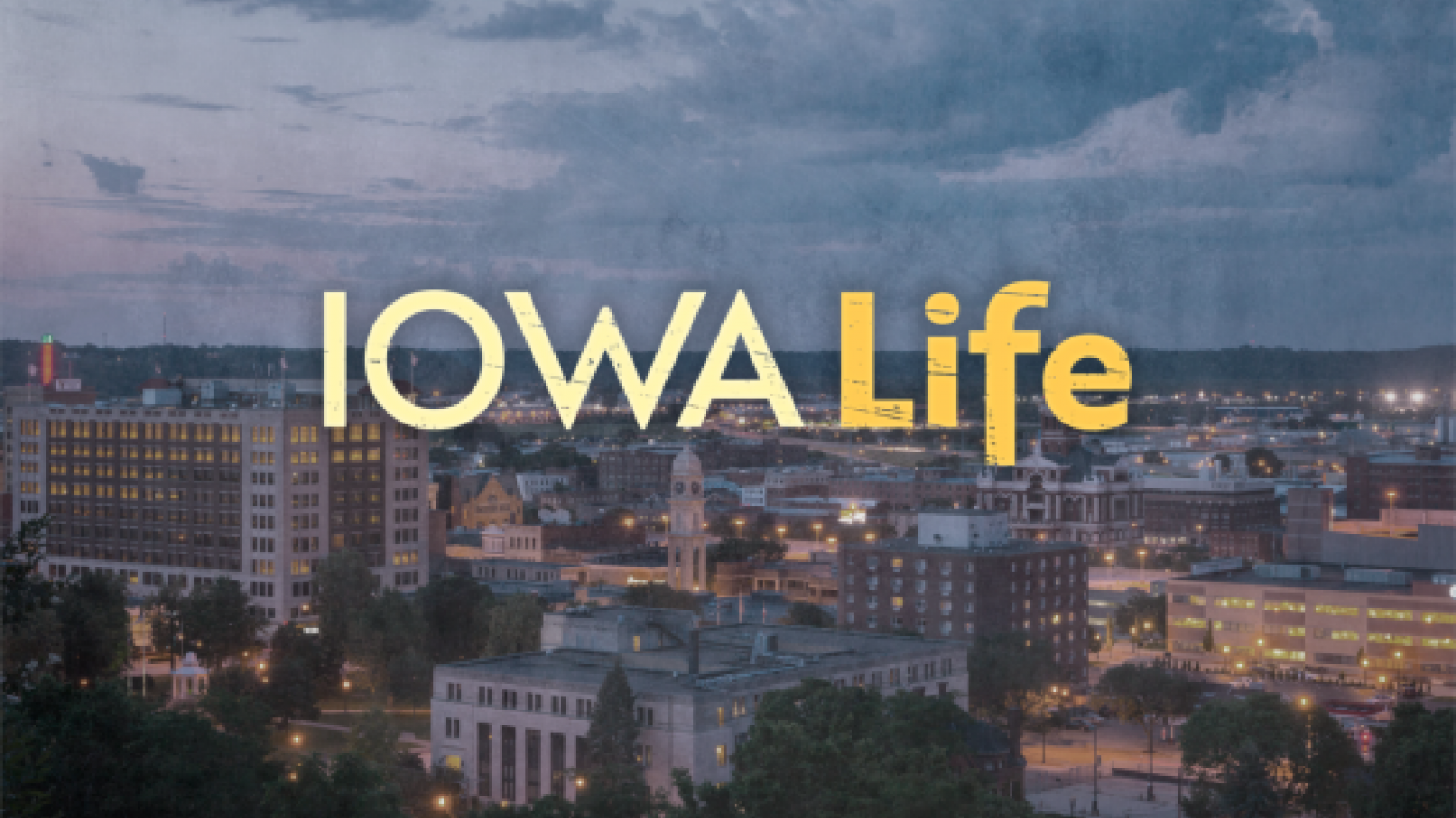 An airial view of the Des Moines skyline with text Iowa Life over the image