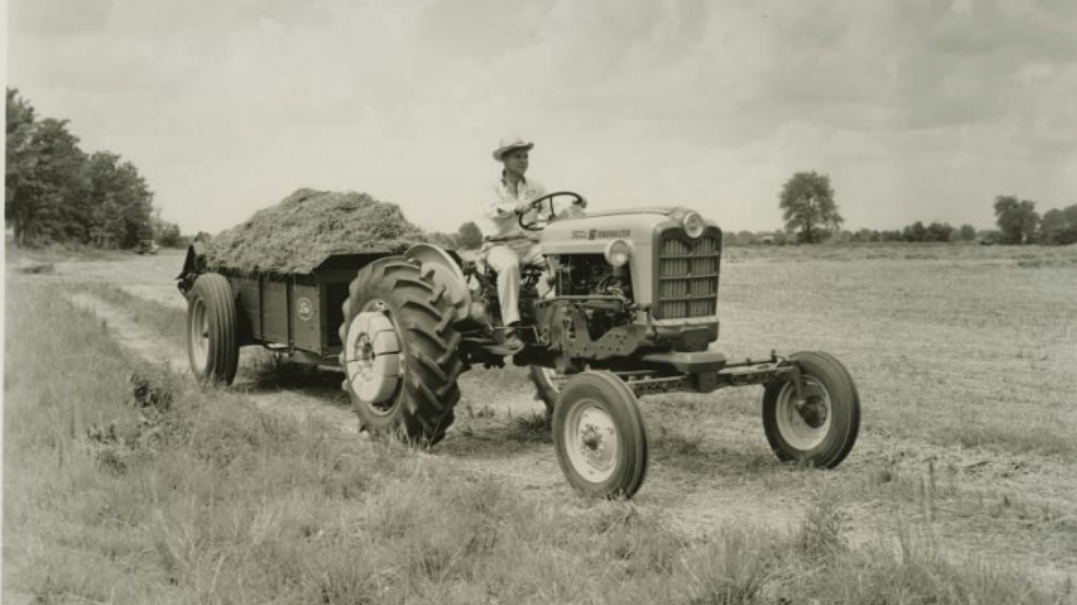 Henry Ford tractor in field with cart behind