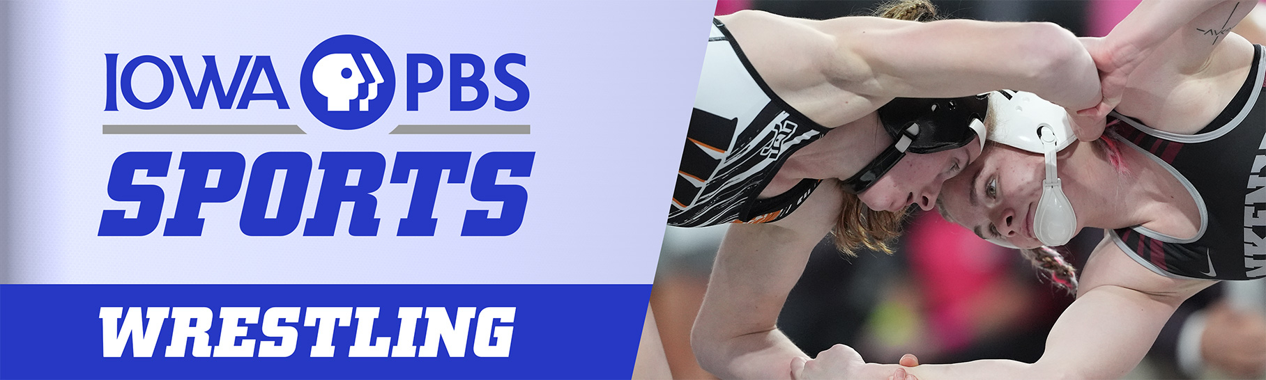 Two females are head to head gripping one another's arms.