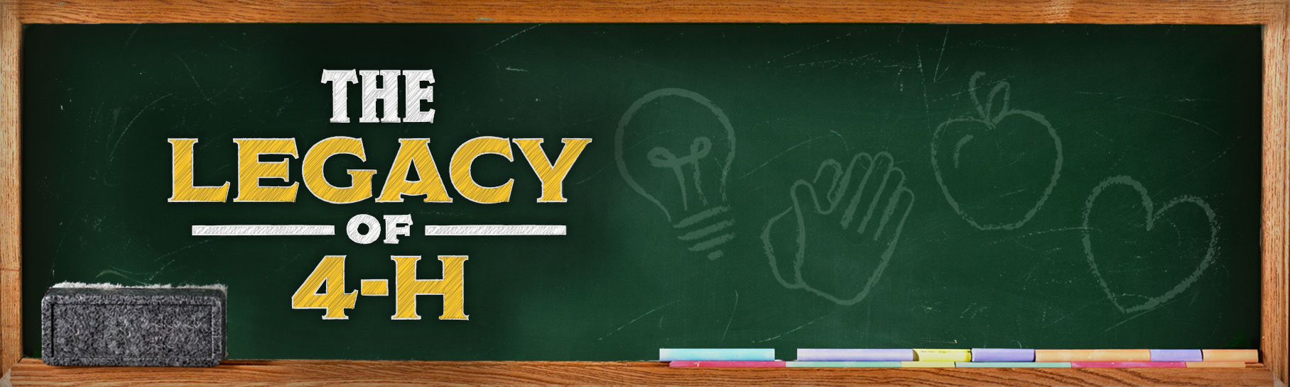 A green chalkboard with "The Legacy of 4-H" in type and four symbols - a light bulb, hands, an apple and a heart - drawn in chalk.
