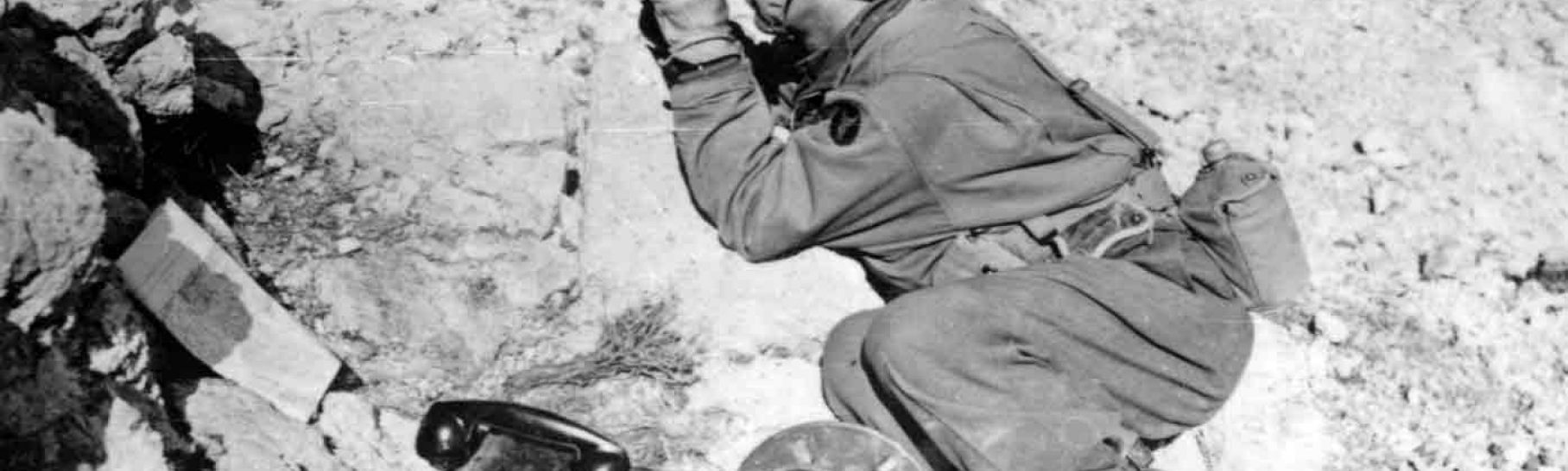 An Iowa soldier, part of the 34th Division, looking through binoculars in North Africa in 1943.